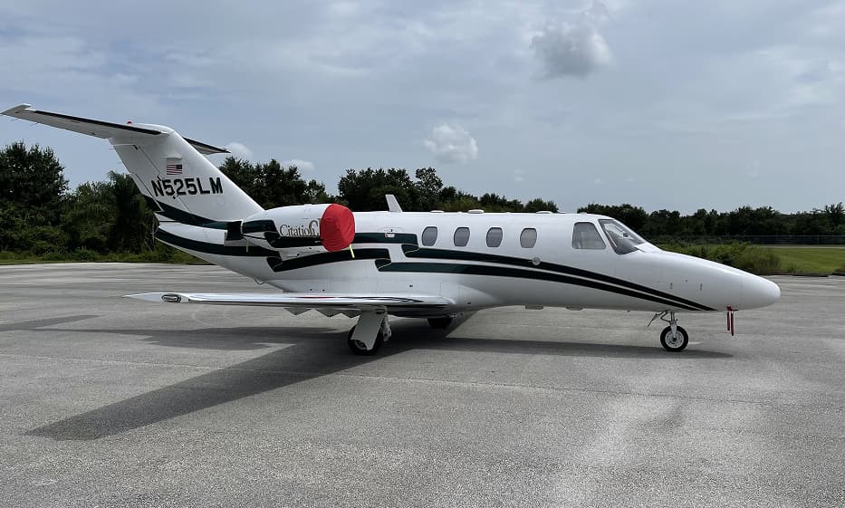 Business jet before aircraft painting, with original paint stripped at Ace Aircraft Refinishing